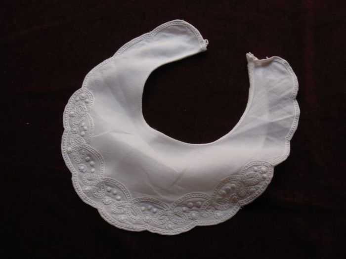 White cotton hand stitched infant bib