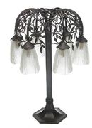 An Art Deco style patinated wrought-metal and molded glass table lamp